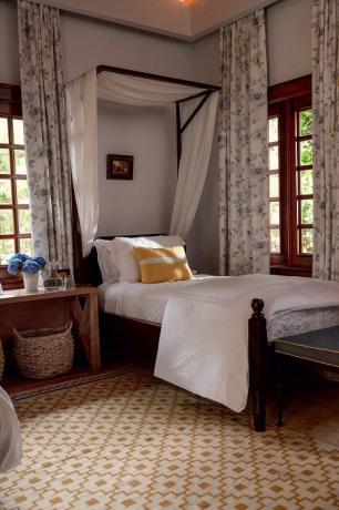 Nyaman kamar tidur didekorasi dengan gaya Spanyol dengan dinding bercat putih dan jendela kayu gelap. | Foto: Thiago Molinos (Tiago Molinos).